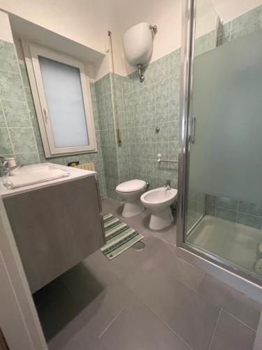 a bathroom with a toilet and a sink and a shower at Casa Luna in Pomezia