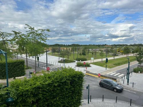 a car driving down a street in a city at Immodēly & la Magie de Disney in Serris
