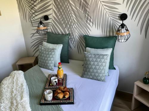 a bed with a tray of food on it at Immodēly & la Magie de Disney in Serris