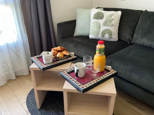 a living room with two tables with drinks and a couch at Immodēly & la Magie de Disney in Serris