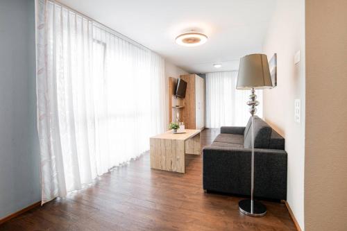 a living room with a couch and a window at Wohntel - wohnen wie im Hotel in Sevelen