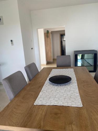 a large wooden table with a black plate on top at Holiday Home Mihaela in Višnjan