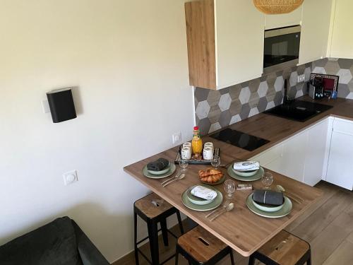 a small kitchen with a wooden table with food on it at Immodēly & la Magie de Disney in Serris