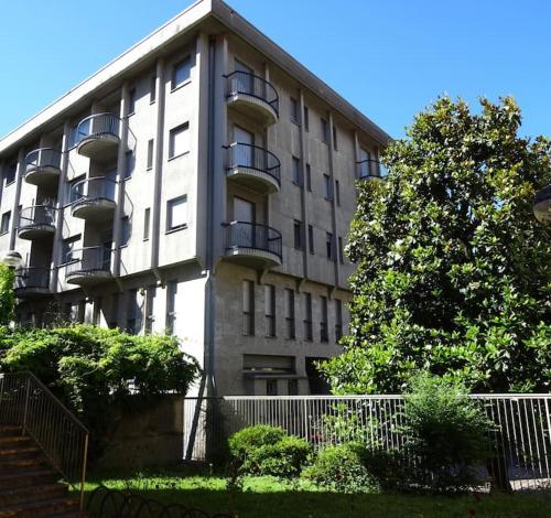 a large building with balconies on the side of it at Ampio monolocale vicino al lungolago di Lecco in Lecco