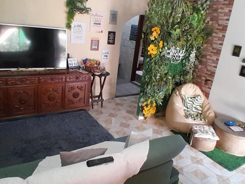 马里卡HOSTEL em Itaipuaçu próximo a praia e terminal da rua 01的带电视和沙发的客厅
