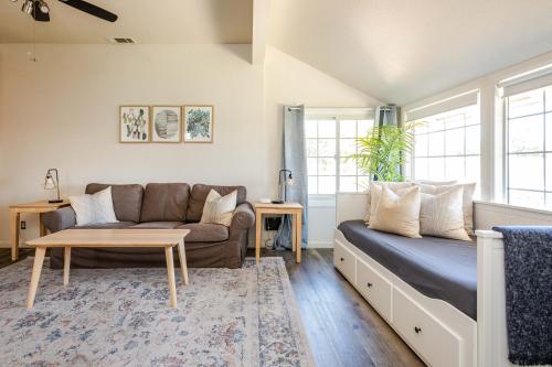 a living room with a couch and a table at Den Street Cottage in Los Alamos