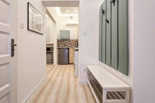 a hallway with a bench and a kitchen in a house at Eda Budapest Apartment in Budapest