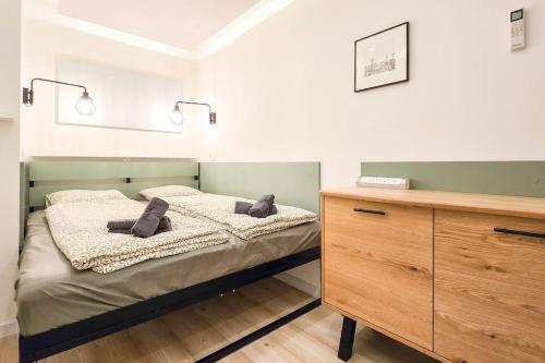 a bedroom with a bed and a wooden dresser at Eda Budapest Apartment in Budapest