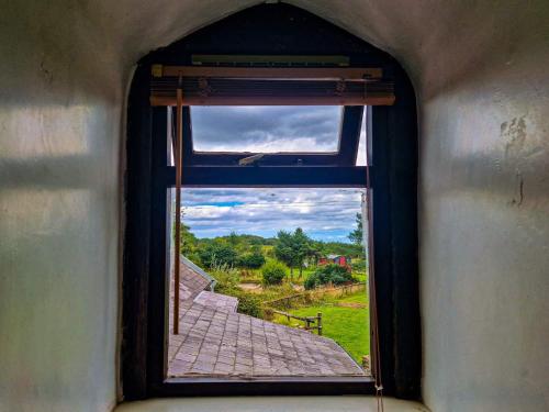 an open window with a view of a pathway at Clyne Farm Centre in The Mumbles