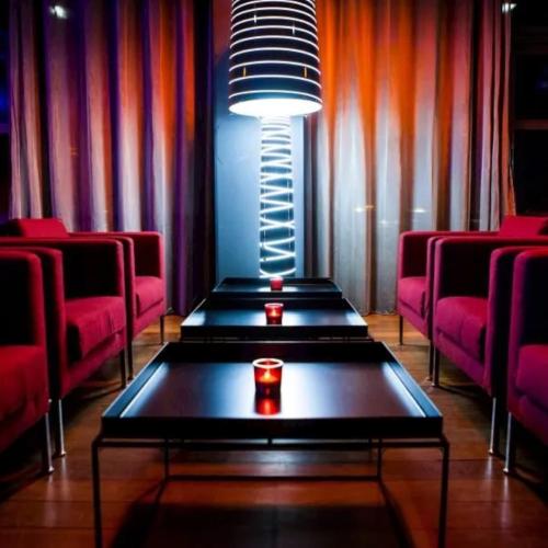 a room with red chairs and a table and a light at Immodēly & la Magie de Disney in Serris