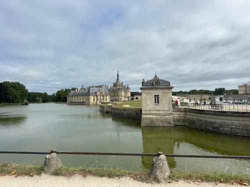 a view of a river with a castle in the background at Immodēly & la Magie de Disney in Serris