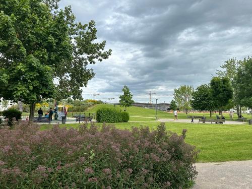 a park with benches and trees and grass and flowers at Immodēly & la Magie de Disney in Serris