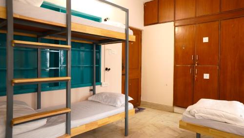 a bunk bed room with two bunk beds in it at Roambay - Gokulam in Mysore