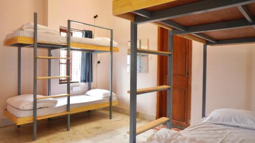 a room with two bunk beds and a bed at Roambay - Gokulam in Mysore