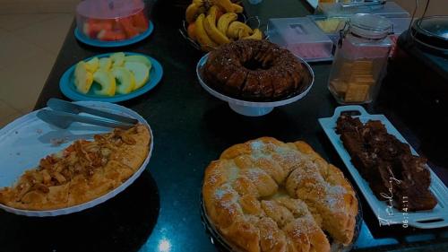 a table topped with different types of pastries and fruit at GRAN HOTEL in Três Lagoas