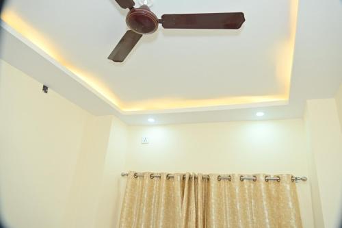 a bathroom with a ceiling fan and a shower curtain at THE Temple view- 100 meter to Vishwanath mandir in Varanasi