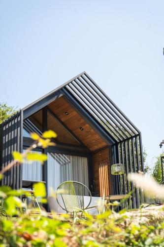 a small house with tables and chairs in front of it at Bruval Eco Retreat in Sandim