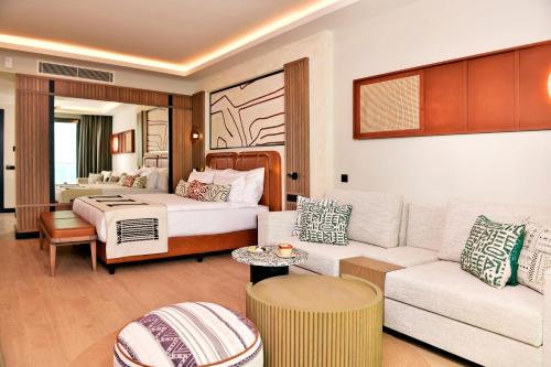 a living room with a couch and a bed at Ethno Belek in Belek