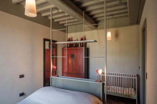 a bedroom with a bed and a mirror at Podere San Pasquale - La Vigna in Castiglione dʼOrcia