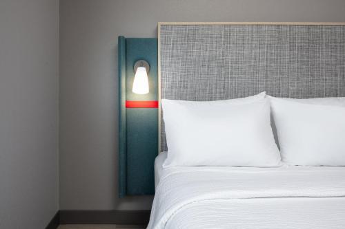 a bedroom with a bed with a red and green door at avid hotel North Platte by IHG in North Platte