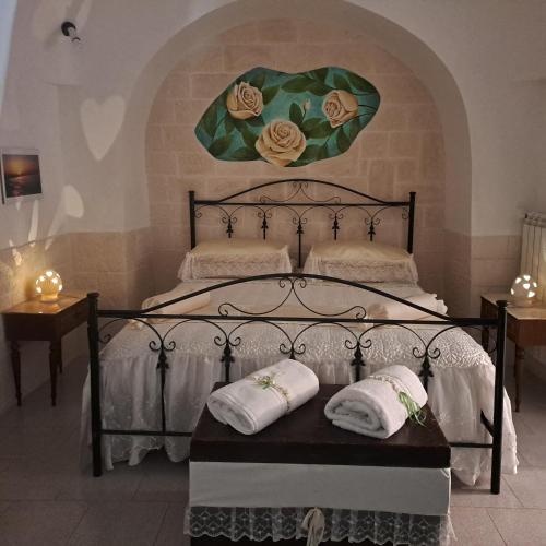 a bedroom with a bed with two pillows on it at Trulli di Rosa in Locorotondo