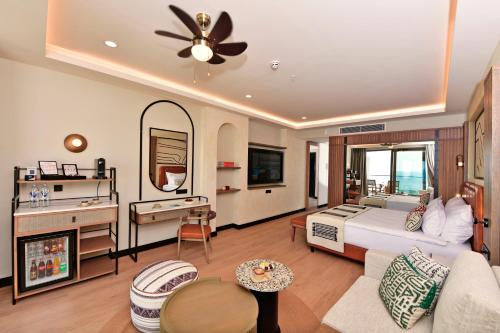 a bedroom with a bed and a living room at Ethno Belek in Belek