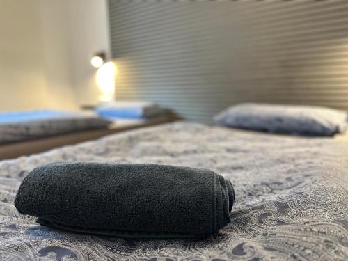 a black pillow sitting on top of a bed at Rhaunen Apartments in Rhaunen