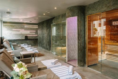 a restaurant with a row of tables and chairs at voco Winchester Hotel & Spa by IHG in Winchester