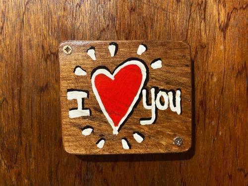 a wooden cutting board with a red heart on it at Amaca Eco Station in Iquitos