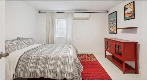 a bedroom with a bed and a red dresser at Historic New Orleans in the Treme in New Orleans