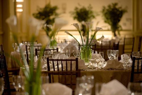 a table with glasses and flowers on it at Falls Church Marriott Fairview Park in Falls Church