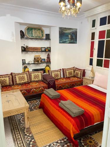 a living room with a bed and a couch at Villa Dar Lghzal Summer Promo Airport Pick-Up & Private Dining in Heart of Rabat in Rabat