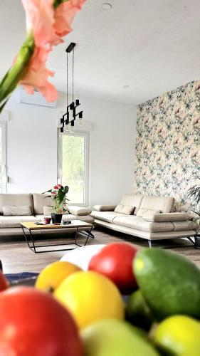 a living room with couches and fruits on the floor at Casa Rado in Banja Luka