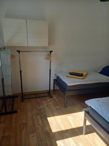 a room with two beds and a wooden floor at Zastávka v lázeňském trojúhelníku apartmán 2 in Smrčina