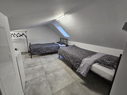 a bedroom with two beds in a room at Neubau Ferienwohnung mit Balkon in Gronau
