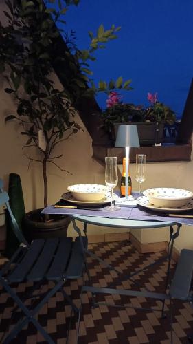 a table with plates and wine glasses on it at SUN Holiday in Salò