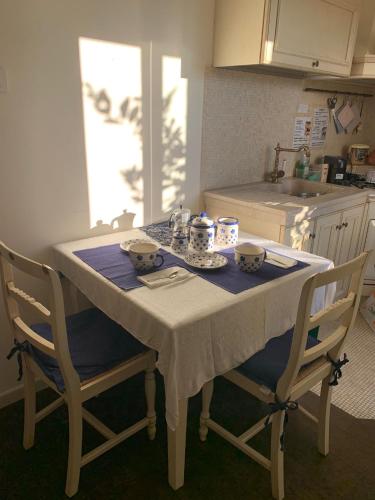 a kitchen with a table with two chairs and a sink at SUN Holiday in Salò