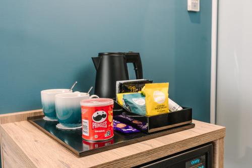 a tray with food and drinks on a table at voco Winchester Hotel & Spa by IHG in Winchester