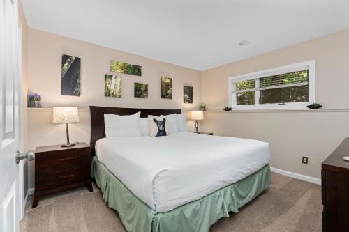 a bedroom with a large white bed and a window at Three Ridges 74 with Wintergreen Advantage in Wintergreen