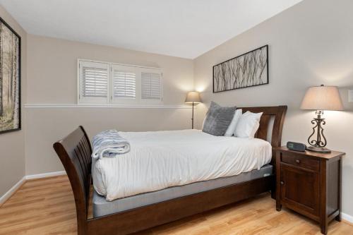 a bedroom with a bed and a night stand with a lamp at Laurelwood 84 with Wintergreen Advantage in Wintergreen
