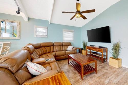 a living room with a couch and a flat screen tv at The Orange Crush - 5BR Beachfront Family Retreat in Ocean City
