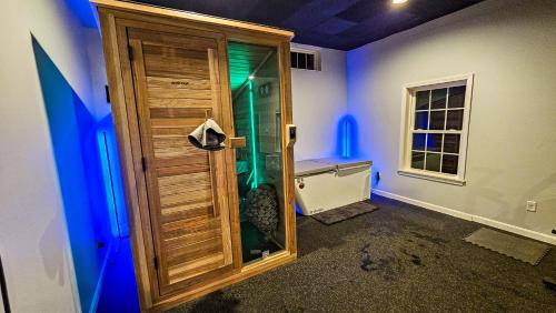 a bathroom with a shower with a wooden door at Mountain View Suite in Danbury