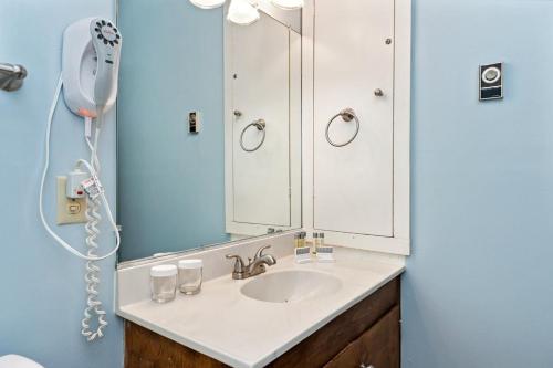 a bathroom with a sink and a mirror at Laurelwood 80 with Wintergreen Advantage in Wintergreen