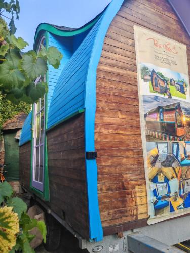 a building with a poster on the side of it at Pura Vida Downtown Tiny houses in Bucharest