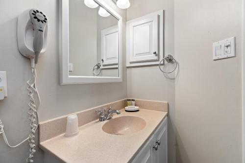 a bathroom with a sink and a mirror at Laurelwood 84 with Wintergreen Advantage in Wintergreen
