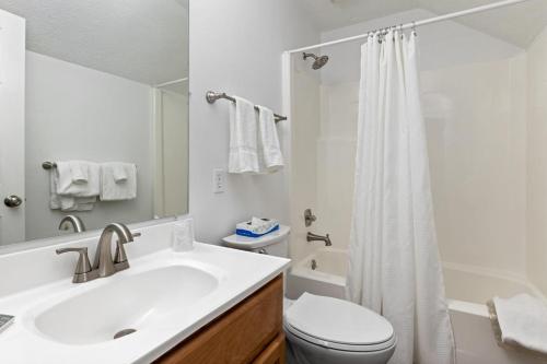 a bathroom with a sink and a toilet and a shower at Laurelwood 25 with Wintergreen Advantage in Wintergreen
