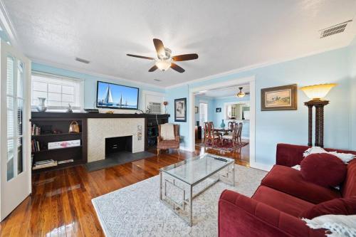 a living room with a red couch and a fireplace at Downtown Loft with Parking - Steps to Restaurants & Nightlife in Melbourne