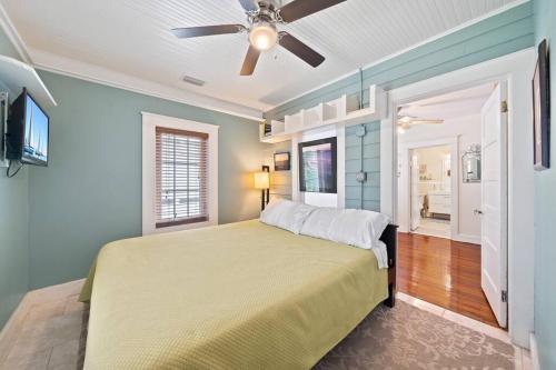 a bedroom with a bed and a ceiling fan at Downtown Loft with Parking - Steps to Restaurants & Nightlife in Melbourne
