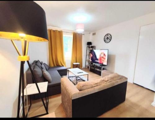 a living room with a couch and a tv at Entire 2 bed home, North Shields, UK FREE parking in North Tyneside