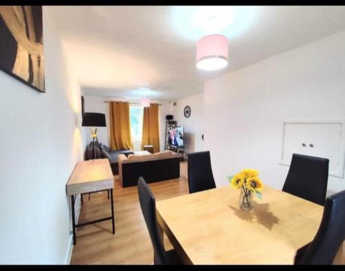 a dining room and living room with a table and chairs at Entire 2 bed home, North Shields, UK FREE parking in North Tyneside
